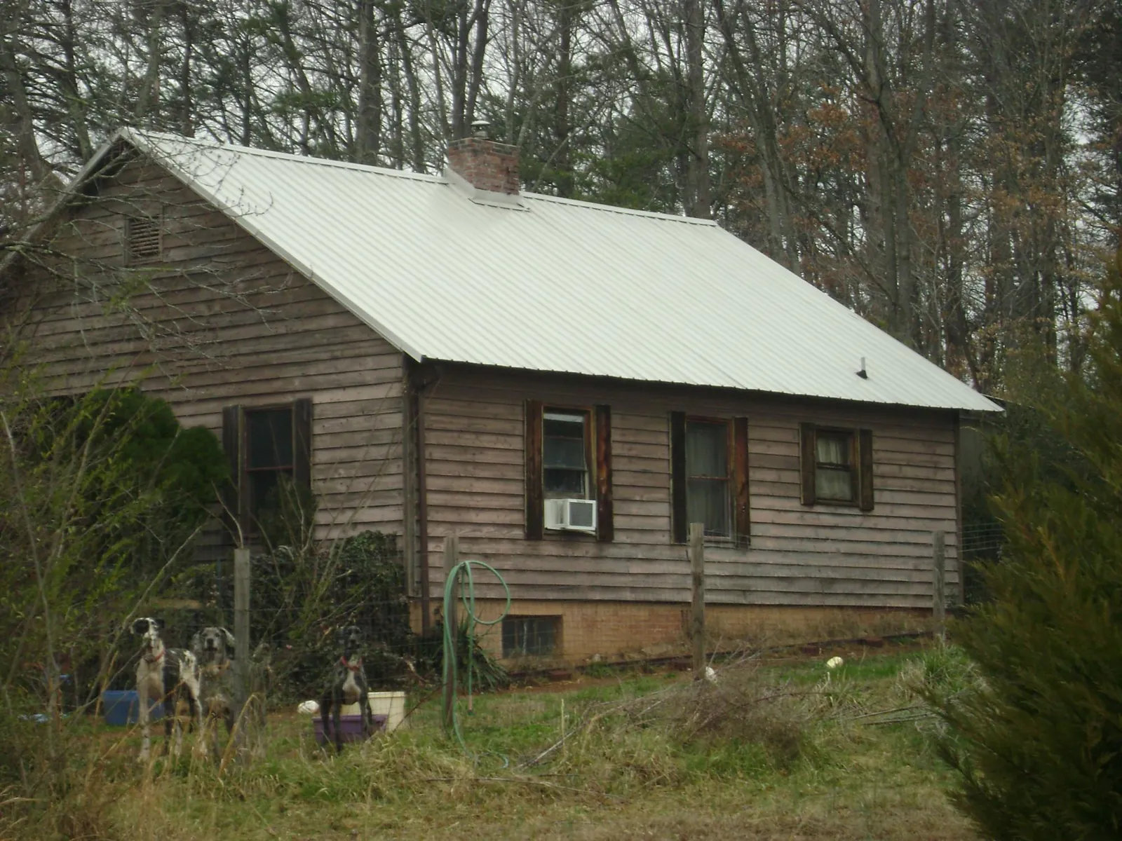 White metal roof on an old wood sided farmhouse, from a Metal Roof Installation job in Margaret